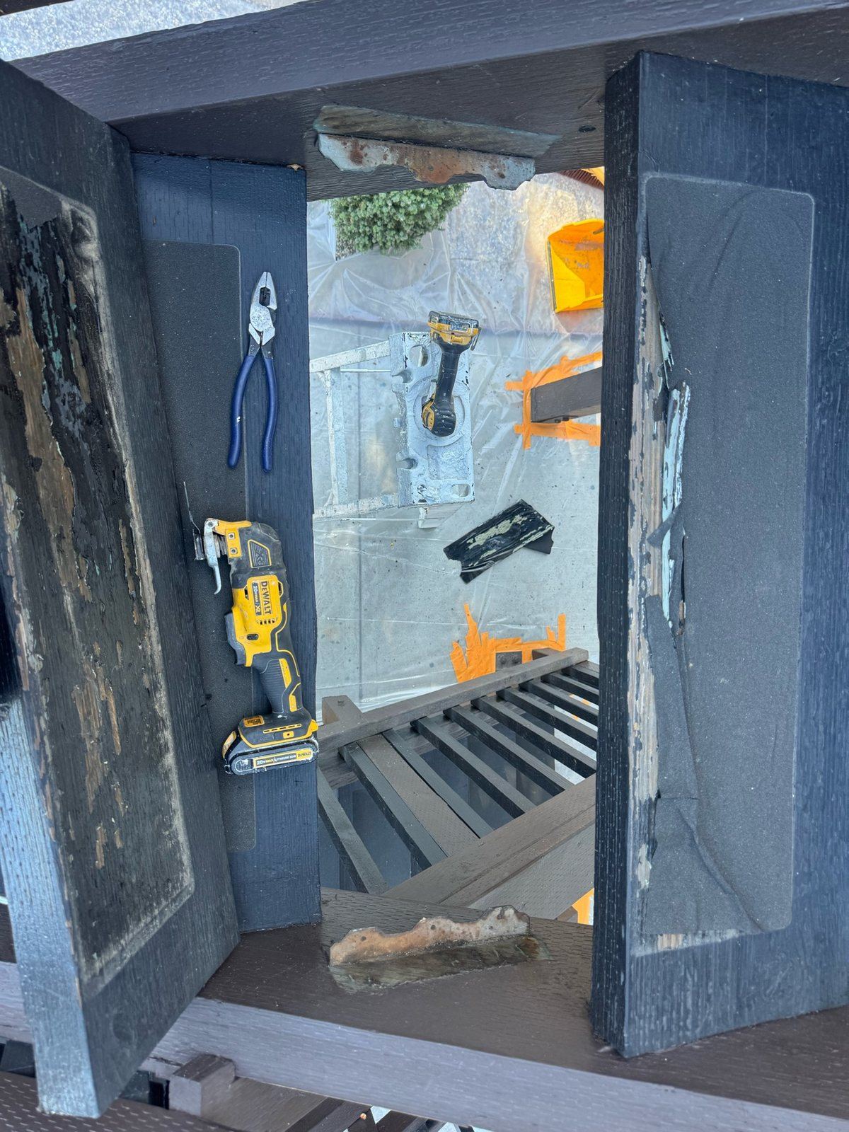 Close-up of a stair tread being cut out and replaced during a repair