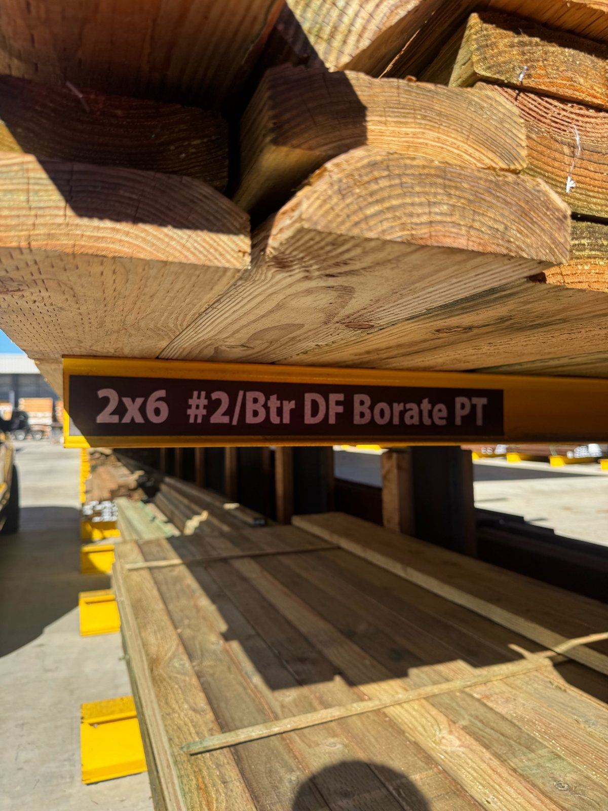 Stack of 2x6 pressure-treated Douglas fir lumber selected for a deck repair