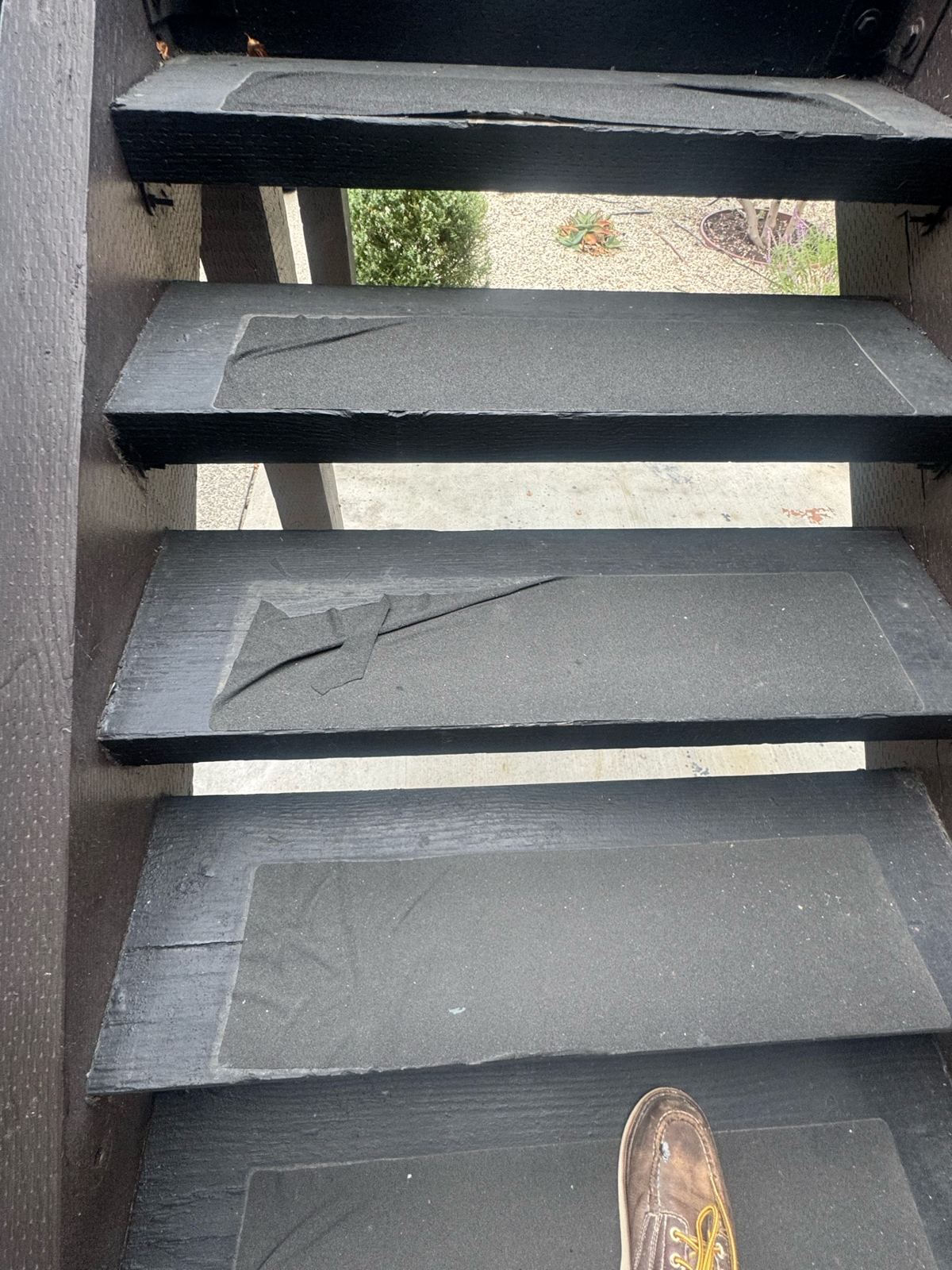 Before photo of exterior stair treads with cracked and peeling tread material